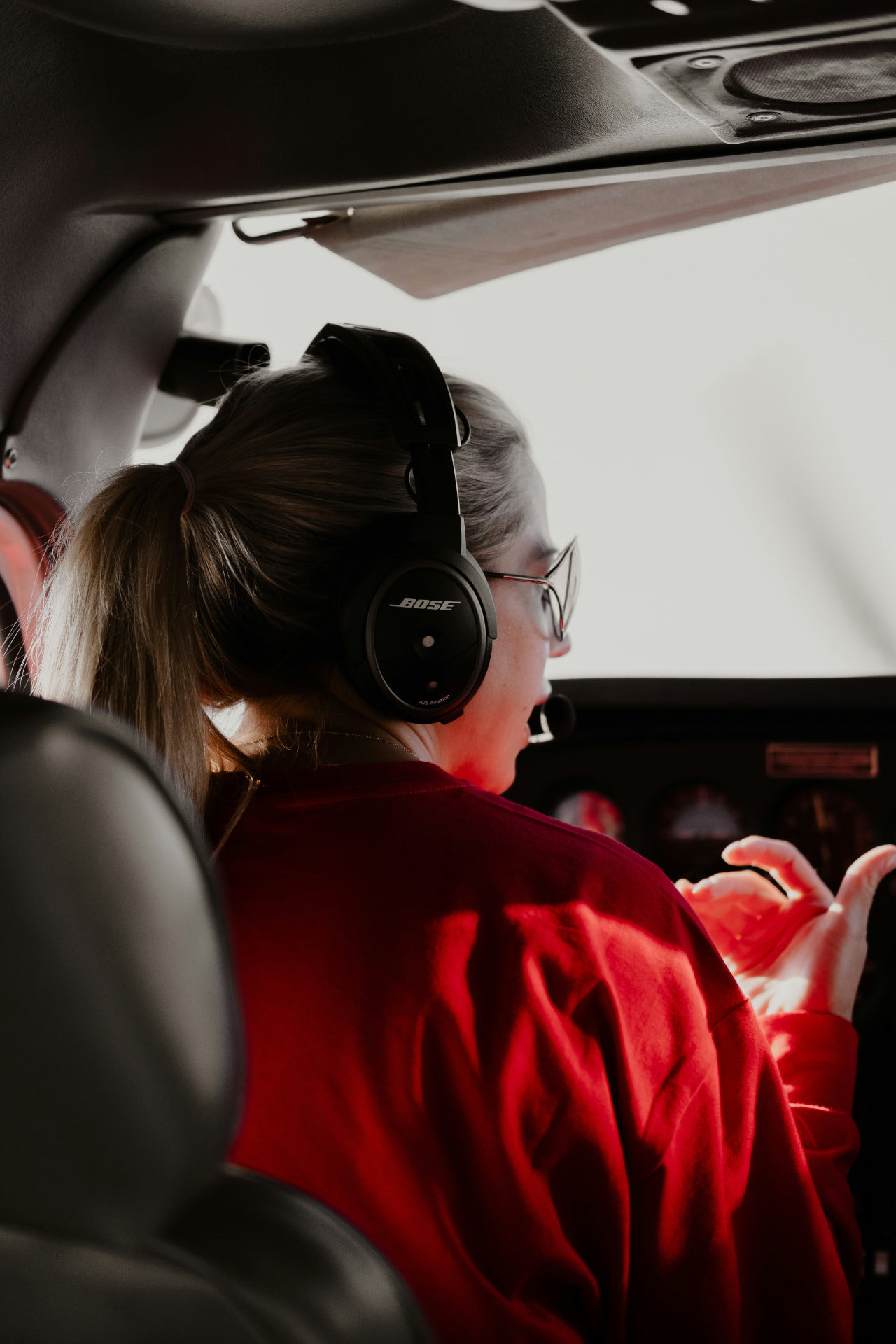 An instructor coaching a student from the right seat of a training aircraft